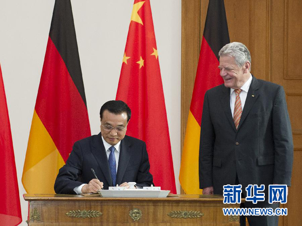 10月10日，國務院總理李克強在柏林會見德國總統高克。這是李克強總理在高克總統的陪同下在貴賓簿上簽字。 新華社記者 王曄 攝 